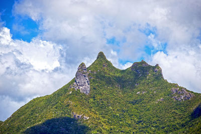 Low angle view of mountain against cloudy sky