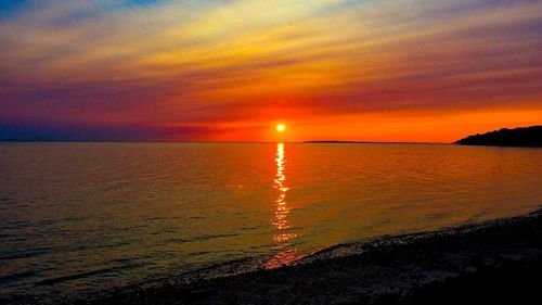 Scenic view of sea against romantic sky at sunset