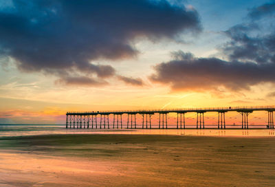 Scenic view of beach against sky during sunset