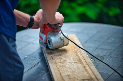 Close-up of man working on wood