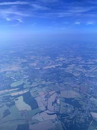 Aerial view of landscape against blue sky