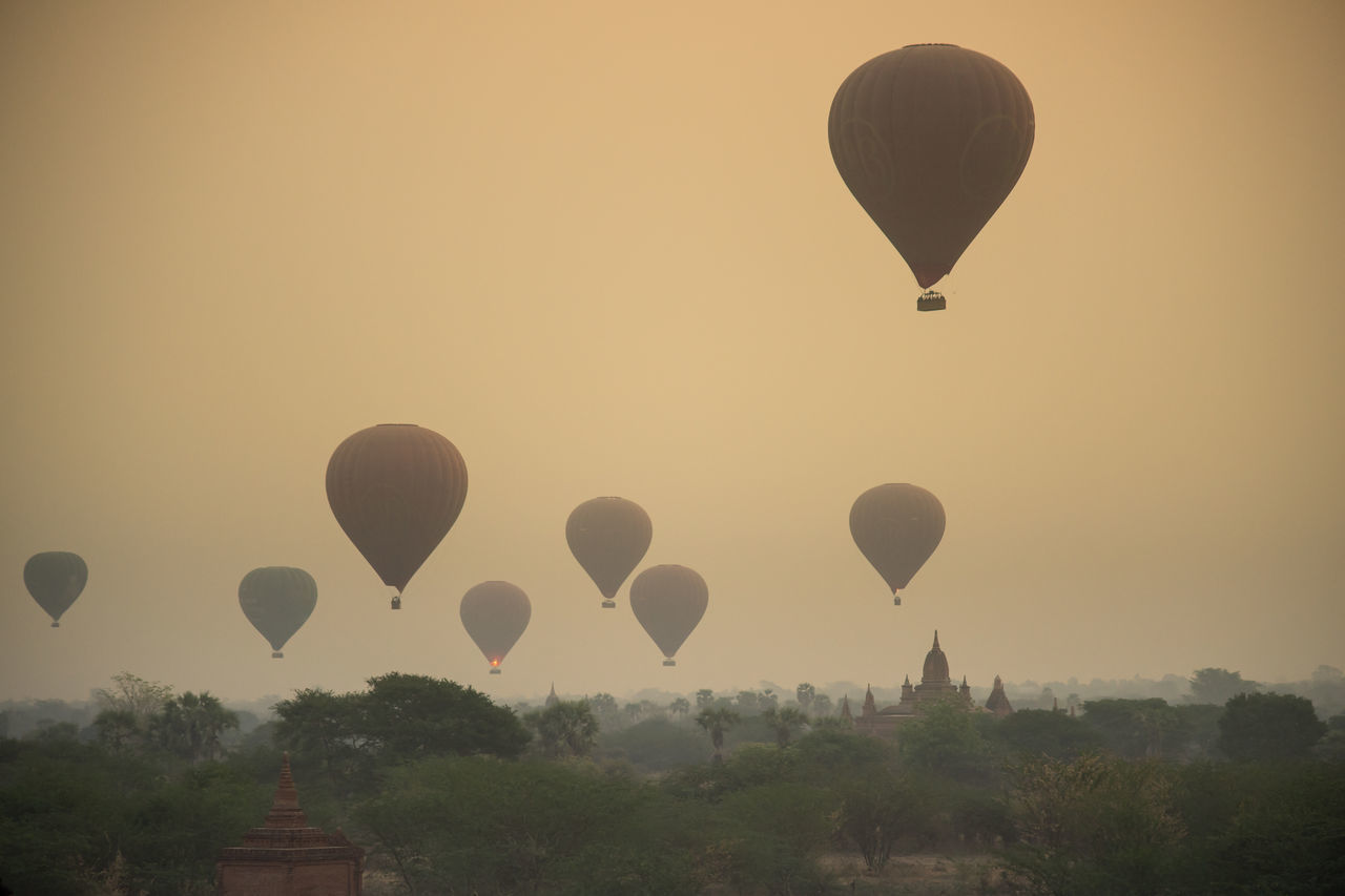 HOT AIR BALLOONS FLYING IN SKY DURING SUNSET