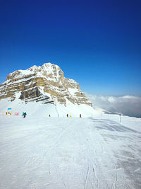 Scenic view of snowcapped mountain against blue sky