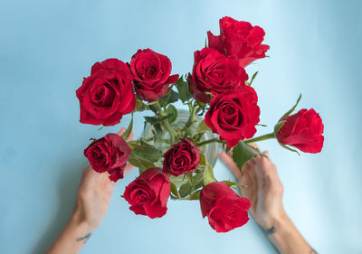 Close-up of hand holding rose bouquet