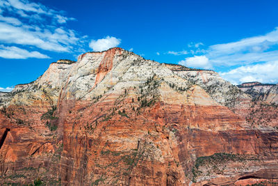 Low angle view of rocky mountain against sky