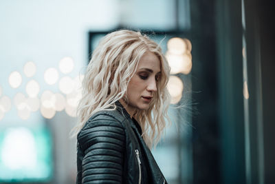 Portrait of young woman looking away outdoors