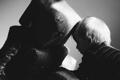 Baby boy playing with stuffed robot at home