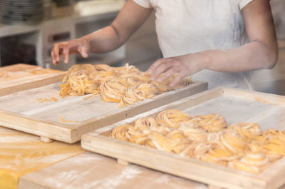 Midsection of man preparing food in kitchen