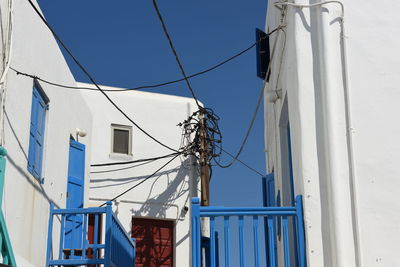 Low angle view of white buildings against clear blue sky