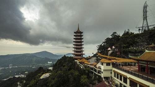 Panoramic view of buildings and trees against sky