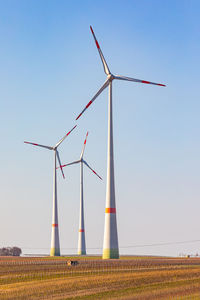 Low angle view of windmills for german energiewende against clear blue sky
