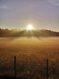 Scenic view of field against sky during sunset