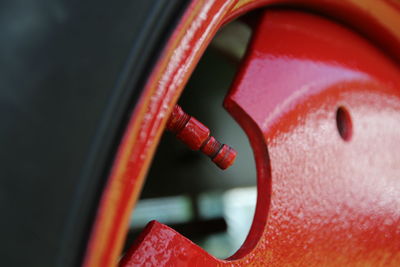 Close-up of red metallic machine