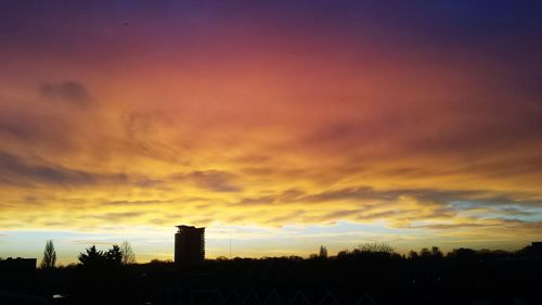 Silhouette of landscape against cloudy sky