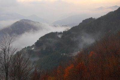 Scenic view of mountains against cloudy sky