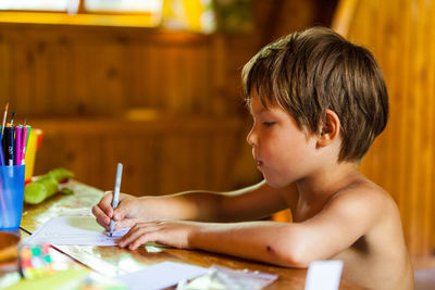 Boy drawing at home