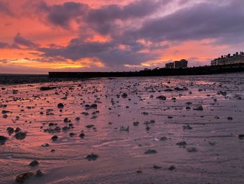 Scenic view of beach against sky during sunset