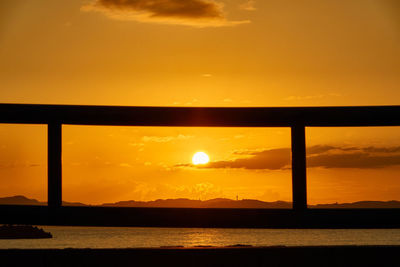 Scenic view of sea against orange sky