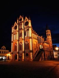 Illuminated clock tower at night