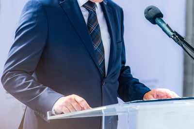 Midsection of businessman using mobile phone