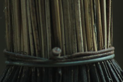 Close-up of bamboo tied up on metal