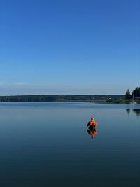 Rear view of man standing in lake