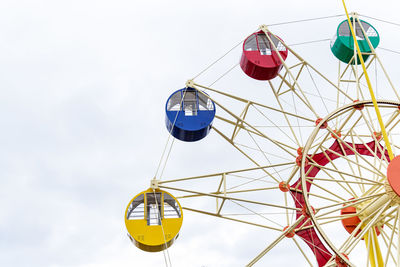 Low angle view of ferris wheel against sky