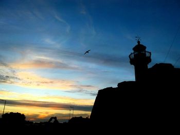 Low angle view of silhouette buildings against sky during sunset