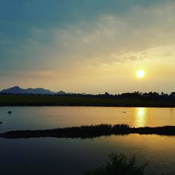 Scenic view of lake against sky during sunset