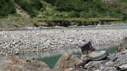 Scenic view of walking boots and river