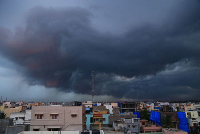 Aerial view of townscape against dramatic sky