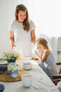 Mother and daughter on table at home