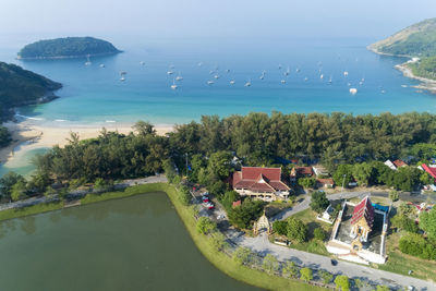 High angle view of swimming pool by sea against trees