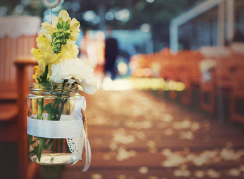 Close-up of flowers in jar on table