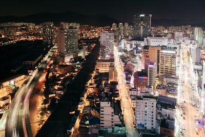 High angle view of illuminated cityscape against sky at night