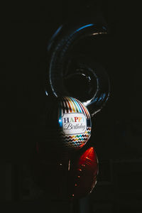 Close-up of birthday balloons in darkroom at home