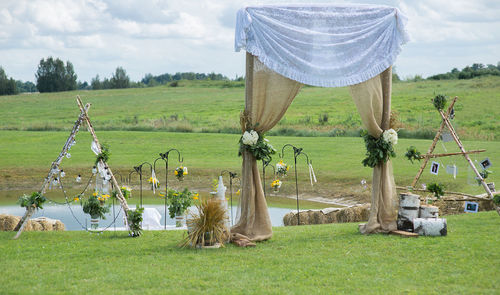 Gazebo on field against sky