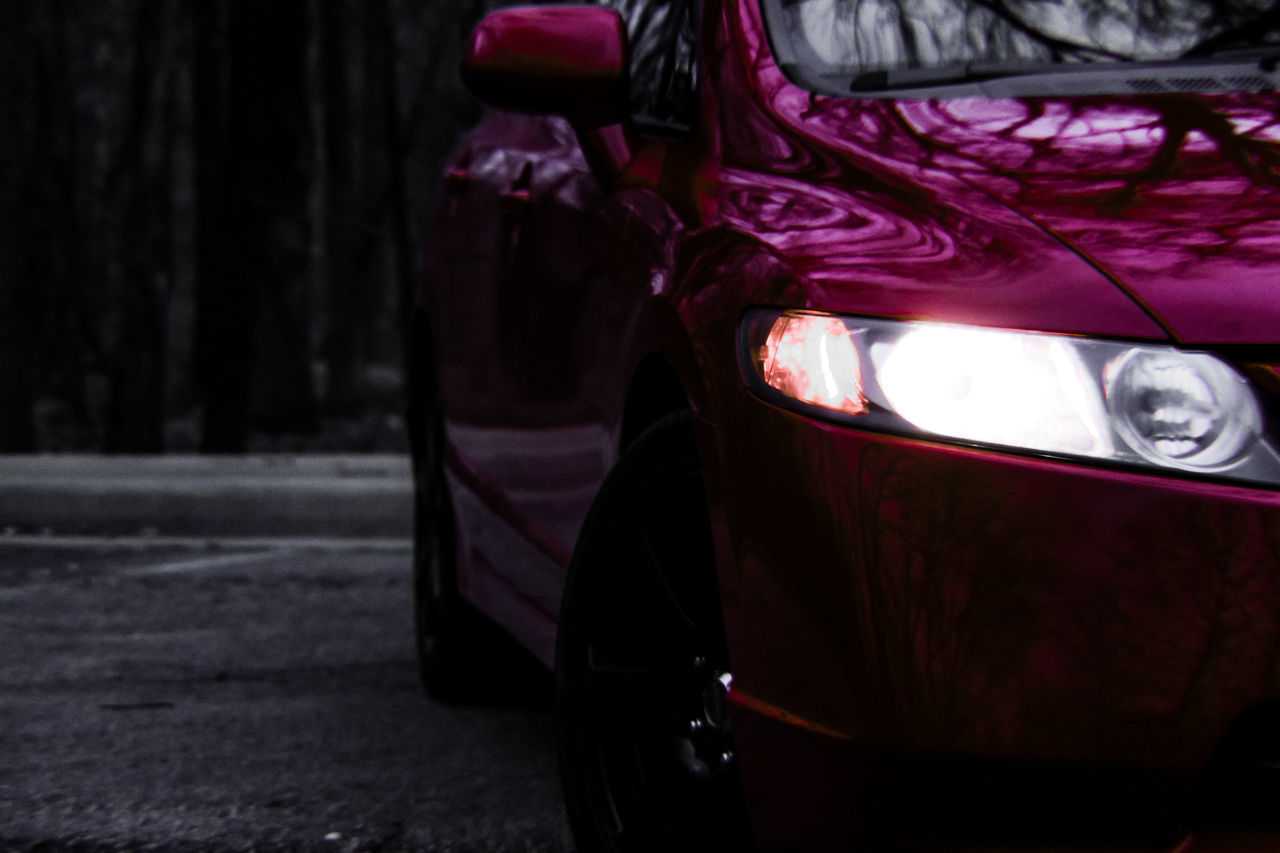 mode of transportation, land vehicle, car, motor vehicle, transportation, focus on foreground, close-up, no people, night, headlight, nature, outdoors, stationary, plant, red, illuminated, travel, street, city, purple