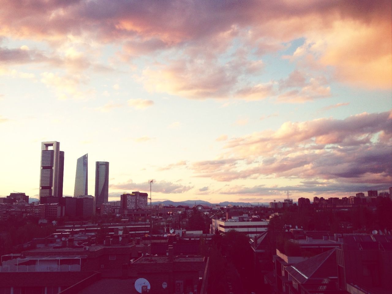 building exterior, architecture, built structure, sunset, sky, city, cloud - sky, cityscape, cloudy, residential structure, residential building, residential district, cloud, orange color, high angle view, house, silhouette, dusk, weather, crowded