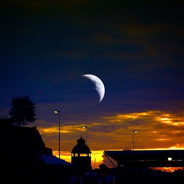 sky, built structure, architecture, building exterior, sunset, cloud - sky, silhouette, dusk, scenics, low angle view, beauty in nature, nature, moon, outdoors, street light, cloud, tranquil scene, no people, tranquility, blue