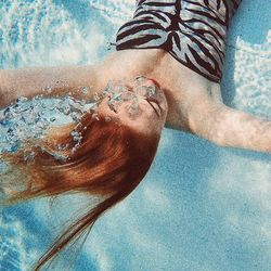 Full length of woman relaxing in pool