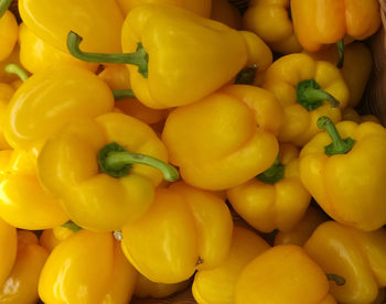Full frame shot of yellow bell peppers for sale at market stall