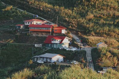 High angle view of houses and trees on field