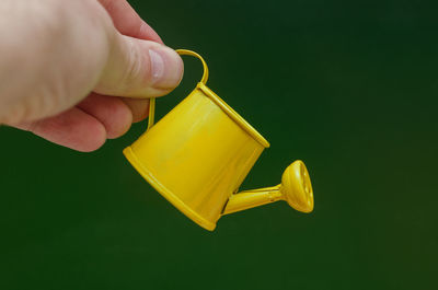 Close-up of hand holding coffee cup