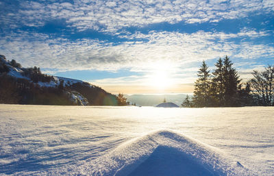 Scenic view of snow covered landscape against sky