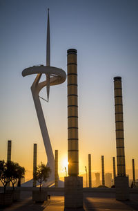 Buildings against clear sky at sunset