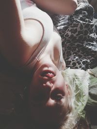 Close-up portrait of woman sleeping on bed