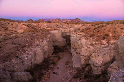 Rock formations on landscape during sunset