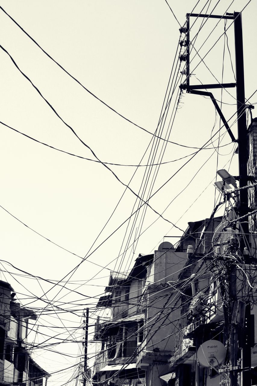 cable, electricity, power line, power supply, fuel and power generation, technology, electricity pylon, low angle view, built structure, connection, complexity, architecture, sky, building exterior, no people, nature, day, outdoors, building, power, telephone line, electrical equipment, tangled