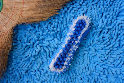 High angle view of brush and broom on rug